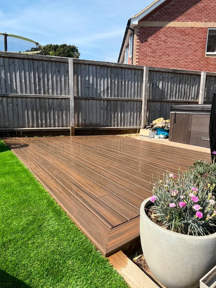 Perspective view of a newly installed Trex Enhance Natural Toasted Sand deck on the Isle of Wight, highlighting the consistent colour, grain pattern and clean lines of the composite boards